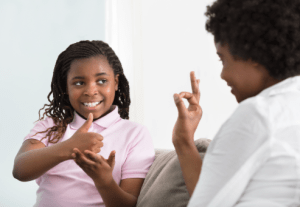 Hand sign language between a 12yr old girl and a grown woman.