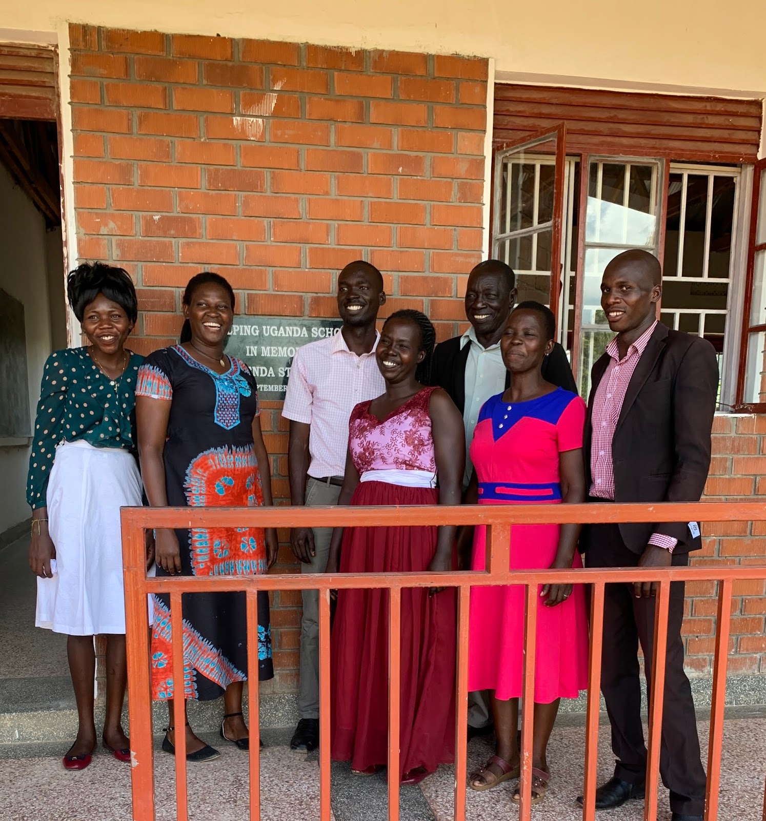 Asili Girls Secondary School teachers and leaders gathered outside the school smiling.